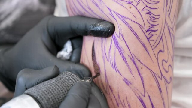 Salon tattoo. Close up of a Tattoo artist working. Tattoo artist make tattoo at the studio. High quality 4k footage