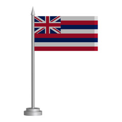 Flag of State of Hawaii (USA) flying on a flagpole stands on the table
