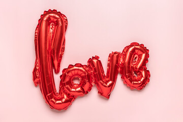 inflatable letters love in red color isolated on pink background Flat lay Top view Holiday card, Happy Valentines day concept Love in air - 486497771