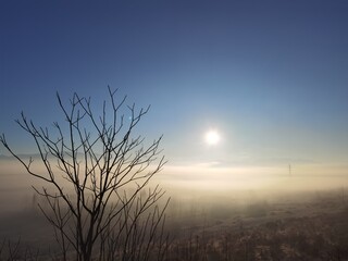 Obraz na płótnie Canvas fog sun sunrise in the morning electric pylong electricity in stavraki villge ioannina perfecture greece