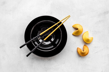 Fototapeta na wymiar Fortune cookies and golden chopsticks. Asian style tabble setting