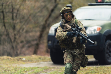 On the go defensive firing at corner by lady soldier . High quality photo