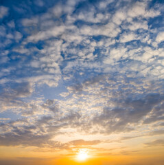 dramatic sunset on blue cloudy sky background, natural evening sky scene