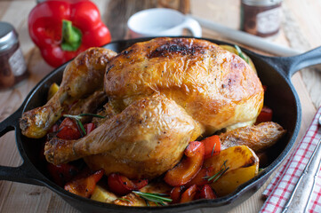 Roast chicken with roasted potatoes and bell peppers