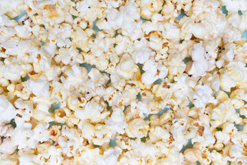 Popcorn texture. Popcorn for watching movies and series. Flat lay. Top view. Quick and tasty snack.
