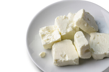 Fototapeta na wymiar Plate of soft white cheese on white background - top view