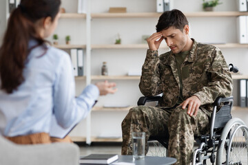 Disabled young man military veteran attending female psychologist
