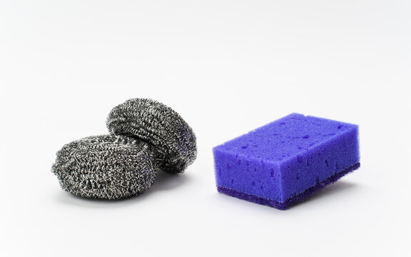 Sponges for washing puda on a light background. Metal and soft sponge for various types of surface cleaning