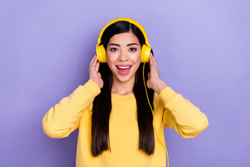 Photo of young excited girl listen playlist melody earphones wow unexpected reaction isolated over purple color background