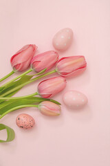 Happy Easter greeting card. Pastel color egg and tulip flower on pink. Spring Holiday celebration