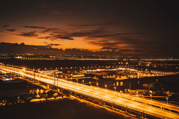 Fototapeta na wymiar Freeway in night with cars light in modern city.