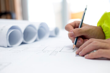 A male engineer is making engineering drawings.