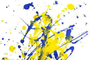 Drops of yellow and blue paint on a white paper background.