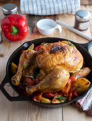 Healthy family meal with roast chicken, roasted potatoes and bell peppers