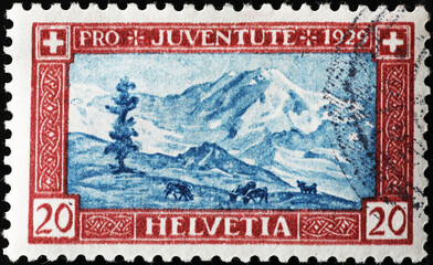 Alpine landscape on vintage swiss postage stamp