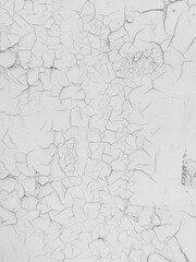 Cracked white paint on the wall as an abstract background.