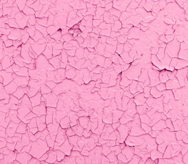 Cracked pink paint on the wall as an abstract background.