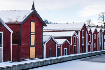 Hudiksvall, Sweden Rows of red warehouses on a canal in downtown.