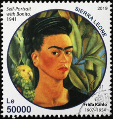 Self portrait with parakeet by Frida Kahlo on postage stamp - obrazy, fototapety, plakaty
