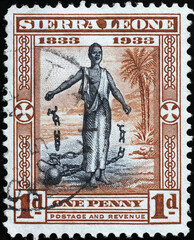 Slave breaking the chains on vintage african stamp