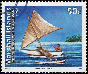 Traditional polynesian sailing boat on postage stamp
