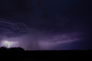 A powerful monsoon thunderstorm at night with lightning