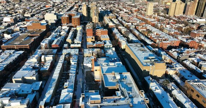 Urban American city covered in winter snow. Residential homes in metropolitan downtown rowhomes. USA life in wintertime.