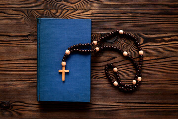 Christian rosary beads with cross and Bible book
