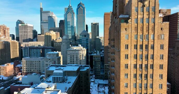 Rising reveal of sky skyline. Skyscraper towers in fresh winter snow. Sunny day. American urban growth population theme. Establishing shot.