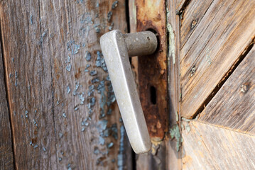 Door handle of an old abandoned house in village