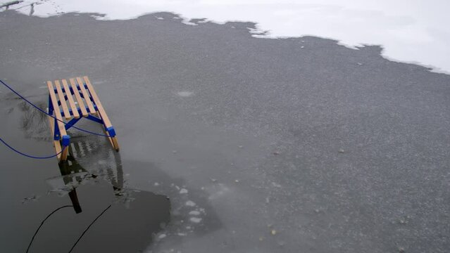 Wooden Sled on Thin Ice Lake, Danger of Drowning in Ice-Hole in Winter