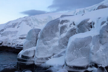 Winter seascape. Snow-covered and icy rocky shore. The Far North. The Barents Sea. Russia, Teriberka, Kola