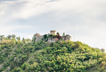 Fototapeta na wymiar Trsat Castle on the Top of the Hill Surrounded by Green Trees in Rijeka, Croatia. Medieval Well Preserved Fortress Ruins in a Natural Environment.