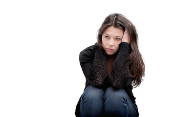 Portrait of a sad teenage girl looking thoughtful about troubles, isolated on white studio...