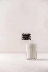 Home baked chocolate cracked cookies stacked on a glass of milk