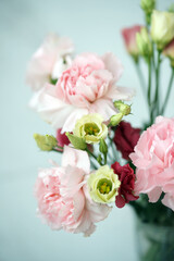 Fototapeta na wymiar Bouquet with pink carnations and eustoma