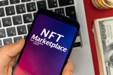 Man working with NFT marketplace application on the smartphone. Future of crypto art, freelance with modern blockchain technology concept photo