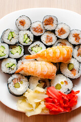 A set of different rolls and sushi on a plate. Top view, vertical photo.