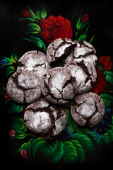 Chocolate cracked cookies on colorful old metal plate