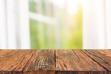 Empty old wooden table top front of blurred white curtains, window, tree and sunlight background. Can be used for display or montage your products.Mock up for display of product.