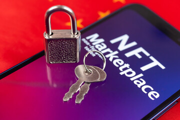 Blocking NFT marketplace in China flag background. Non fungible token, crypto art and blockchain. Top view photo