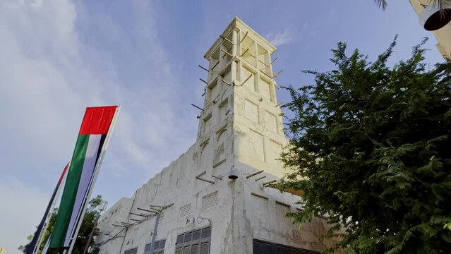 Traditional Arab Wind Tower On Building Roof In Al Fahidi Historical District In Dubai, UAE. dolly-in, tilt-up