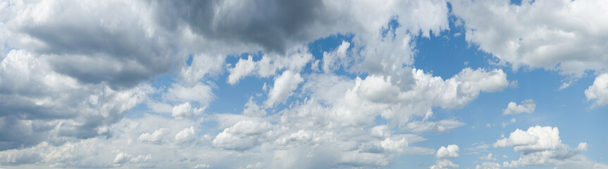 panorama of clouds against the blue sky. Background, wallpaper. Gradient transition from dark to...