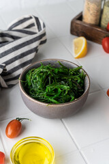 asian chuka salad with minerals and vitamins. on a light background in the composition. beautiful serving in a plate. diet snack