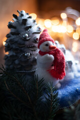 New Year's composition with hand-made Snowman with a red knitted scarf and hat.