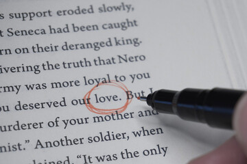 Hand Tracing Word "Love" on White Paper. Close-up of the Text "Love".