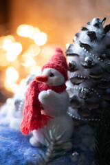 New Year's composition with hand-made Snowman with a red knitted scarf and hat.