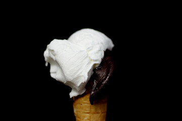 Lemon and chocolate ice cream in a waffle cone - black background