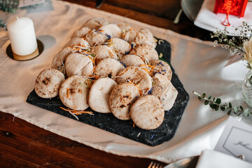 A rustic serving of freshly baked mini sandwiches with a warm, cozy setting.