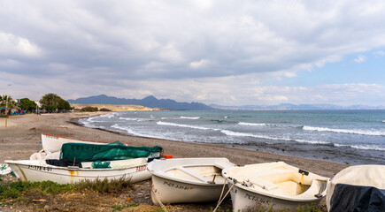 Fototapeta na wymiar beached fishing boats and endless pebble and rock beach on the south coast of Murcia